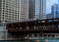 Rush hour scene of Chicago`s elevated `el` train track passing over the Chicago River. Royalty Free Stock Photo